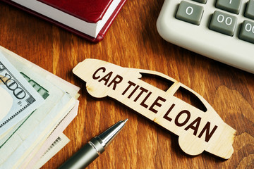 Wall Mural - Car title loan concept. Wooden model of vehicle and money.