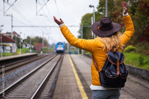 I am late, i missed my train again! Unhappy traveler standing on railroad station and looking to leaving train