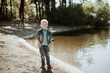 © andreiko - Portrait of cute smiling boy on a summer riverbank.