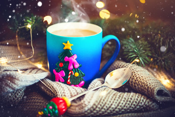 A Cup of hot cocoa in a Christmas mug on the background of Christmas garlands. Merry Christmas and happy New year. Selective focus.