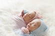 © Alexandritik - The sleeping Newborn gilr and boy lies on the white fur. Newborn twins