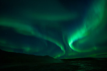 northern lights at the geysir srokkur iceland