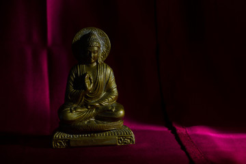 Wall Mural - Bronze colored figurine of Buddha