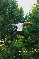 Young man jumping in acrobatic way 