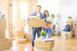 © Krakenimages.com - Beautiful young couple smiling in love holding cardboard boxes, happy for moving to a new home