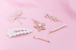 Luxury hair clips on pink fabric with copyspace.