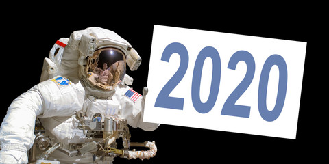 Wall Mural - astronaut in space holding a 2020 white board - new year greeting card - elements of this image are 