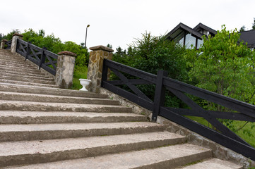  Stone desert staircase in a quiet Scandinavian-style village. Steps among the greenery