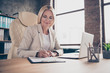 © deagreez - Photo of business lady making notes in her notebook when listening to words of speaker holding pen with hands
