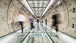© Urbanscape - Motion blur of unidentified Asian people walking in subway tunnel walkway. Underground public transportation, futuristic architecture, city life, or commuter lifestyle concept