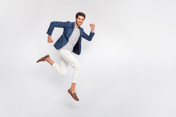 Full length body size view of nice attractive luxurious cheerful cheery glad funny businessman wearing checked blazer jumping running fast movement motion isolated over light white pastel background