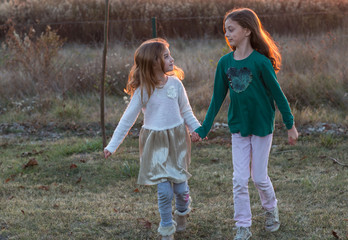 Portrait of two happy pretty smiling sisters. Cute little siblings outdoor.