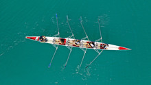 Aerial Drone Photo Of Team Of Athletes Rowing In Sport Canoe In Tropical Exotic Lake