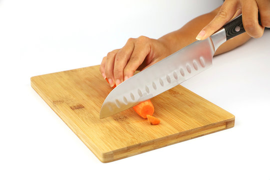 a female chef chopping a carrot