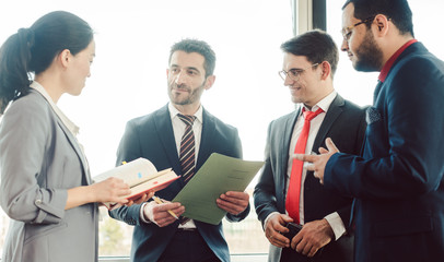 Team of business people having water cooler chat