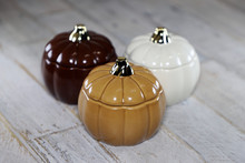 Glass Pumpkins Against Distressed Wooden Surface Backbround