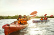 © master1305 - Happy young caucasian group of friends kayaking on river with sunset in the backgrounds. Having fun in leisure activity. Happy male and female model laughting on the kayak. Sport, relations concept.