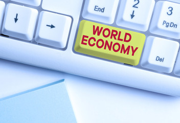 Writing note showing World Economy. Business concept for Global Worldwide International markets trade money exchange White pc keyboard with note paper above the white background