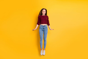 Sticker - Full size photo of pretty millennial jumping wearing maroon sweater isolated over yellow background