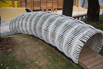 Pipe tunnel for climbing children of white plastic harnesses in the form of caterpillars. Playgrounds, toys, sports.