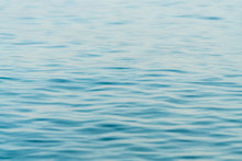 Ripples On Surface Of Blue Water Background