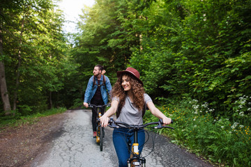 Wall Mural - young tourist couple travellers with electric scooters in nature.