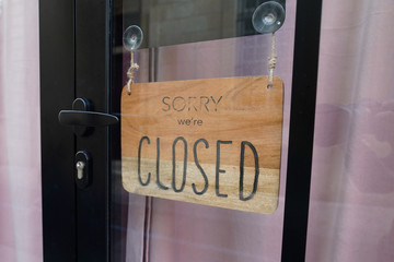 Wall Mural - Sorry we are closed sign wood on shop store windows