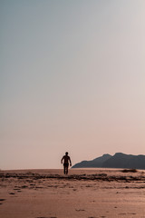 Man walking on sand at the beach