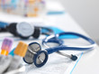 © Westend61 - Health Screening, A stethoscope on a patients blood results after a a consultation