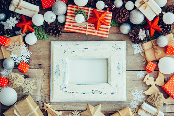 Wall Mural - Christmas background with frame and gift boxes on the wooden tab