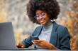 young african american business woman with laptop and mobile phone