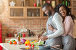 Grateful wife embracing her husband from behind at kitchen