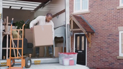 Wall Mural - Man Unloading Boxes From Removal Truck Outside New Home On Moving Day