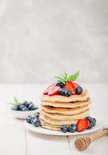 Classic American Pancakes With Fresh Berry On White Wood Background. Summer Homemade Breakfast.