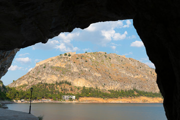 Wall Mural - Rock arch in silhouette with view through to Arvanitia Beach