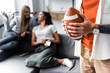 © LIGHTFIELD STUDIOS - selective focus of man holding Rugby Ball in apartment