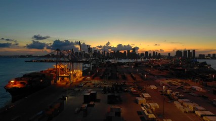Wall Mural - Sunset aerials over Port Miami 4k cranes and cargo with view of Downtown