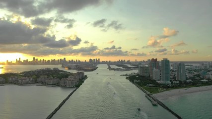 Wall Mural - Aerial video approaching Miami Beach backlit by sunset over harbour 4k