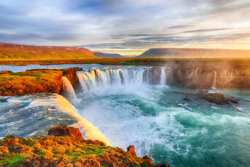 Fantastic sunrise scene of powerful Godafoss waterfall.