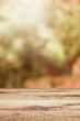 Wooden table and blurred bokeh autumn background.