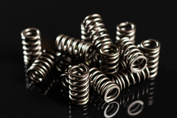 motorcycle valve springs on a black reflective background