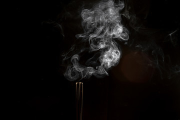 Incense and abstract smoke image on black background,