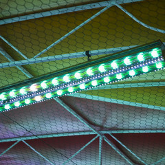 Funfair top at night with green and blue lights