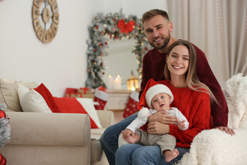 Wall Mural - Happy family with cute baby in room decorated for Christmas holiday