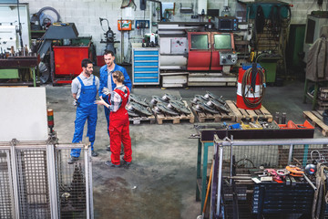 Wall Mural - Workers on the factory floor in discussion