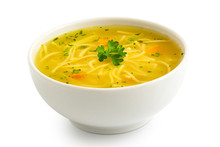 Instant Chicken Noodle Soup In A White Ceramic Bowl Isolated On White. Parsley Garnish.