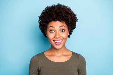 Poster - Unbelievable bargains concept. Portrait of positive cheerful impressed afro american girl hear wonderful news look stare wear casual style pullover isolated over blue color background