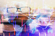 © peshkova - Business theme hologram with glasses on the table background. Concept of search. Double exposure.
