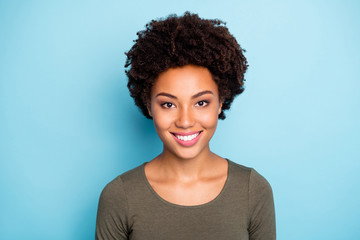 Photo of cheerful cute nice charming fascinating lady looking into camera smiling toothily isolated over blue vivid color background