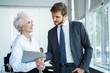 © opolja - Senior mature caucasian female executive ceo discuss report with young colleague